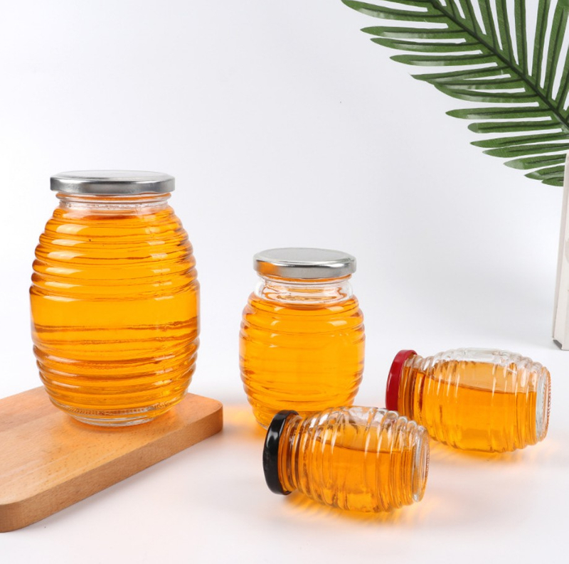 Frascos de miel de vidrio vacío de flint 100ml 250ml 500ml 1000ml Jam Jam Jares Botella en forma de ovalado al por mayor